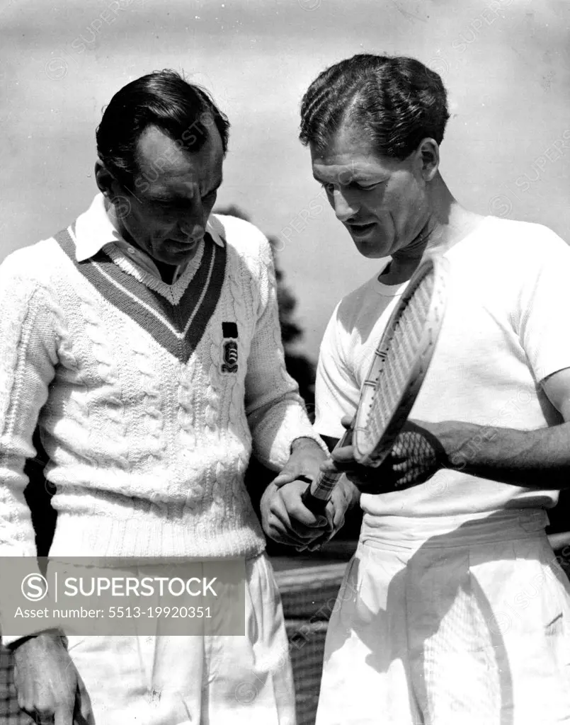 Former Wimbledon champion, Fred Perry (left), flew from America to coach the British Davis Cup team. He is shown advising Tony Mottram on his grip. Britain, however, was beaten 4-1 by Czechoslovakia. Mottram won a singles for Britain. May 19, 1949. (Photo by Reuterphoto).