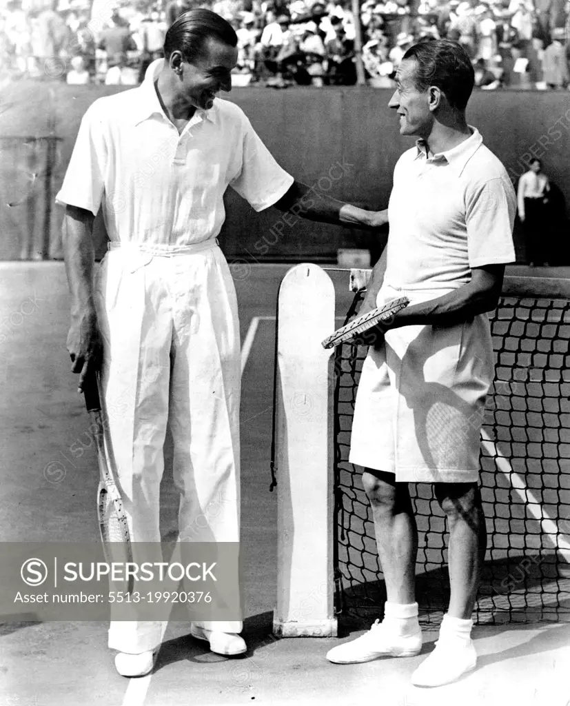 Perry Beats Cochet in Davis Cup.Perry (left) joking with Cochet of France just before the start of their great match in the Davis Cup of the Final round this afternoon July 28 at the Stade Roland ***** in Paris. Perry won his match after a terrific battle with the Frenchman. September 05, 1933. (Photo by The Associated Press of Great Britain Ltd.).