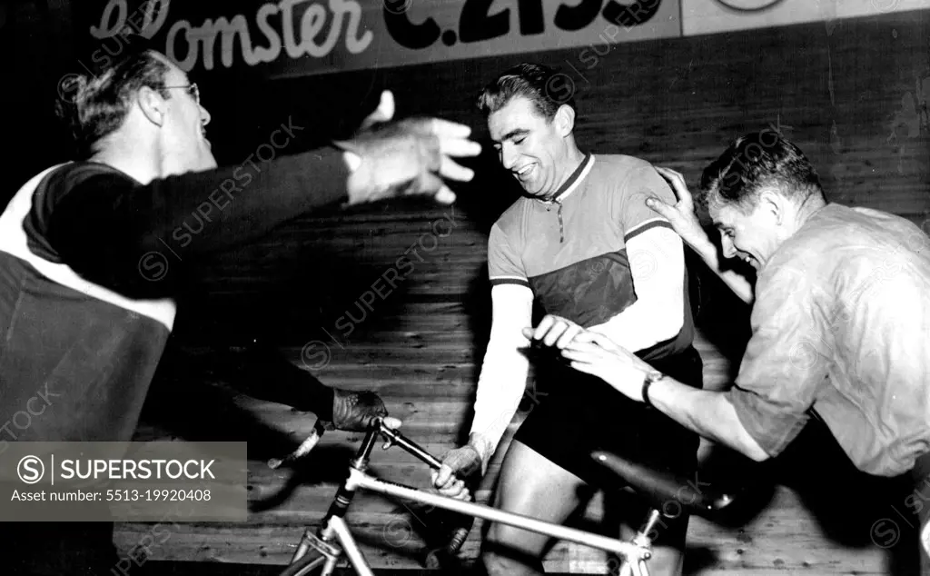 Sid Patterson (Centre) of Australian Jokingly "steals" a bicycle from Arie Van Vliet of Holland (left) during on of their off-Duty Periods in the six-day cycle race now running at Copenhagen, Denmark. Man at right is unidentified the race started December 8.In an off-duty spot of clowning at Copenhagen Patterson pretended to steal a bike from Arie Van Vliet (left), his team mate. August 24, 1955. (Photo by Associated Press Photo).