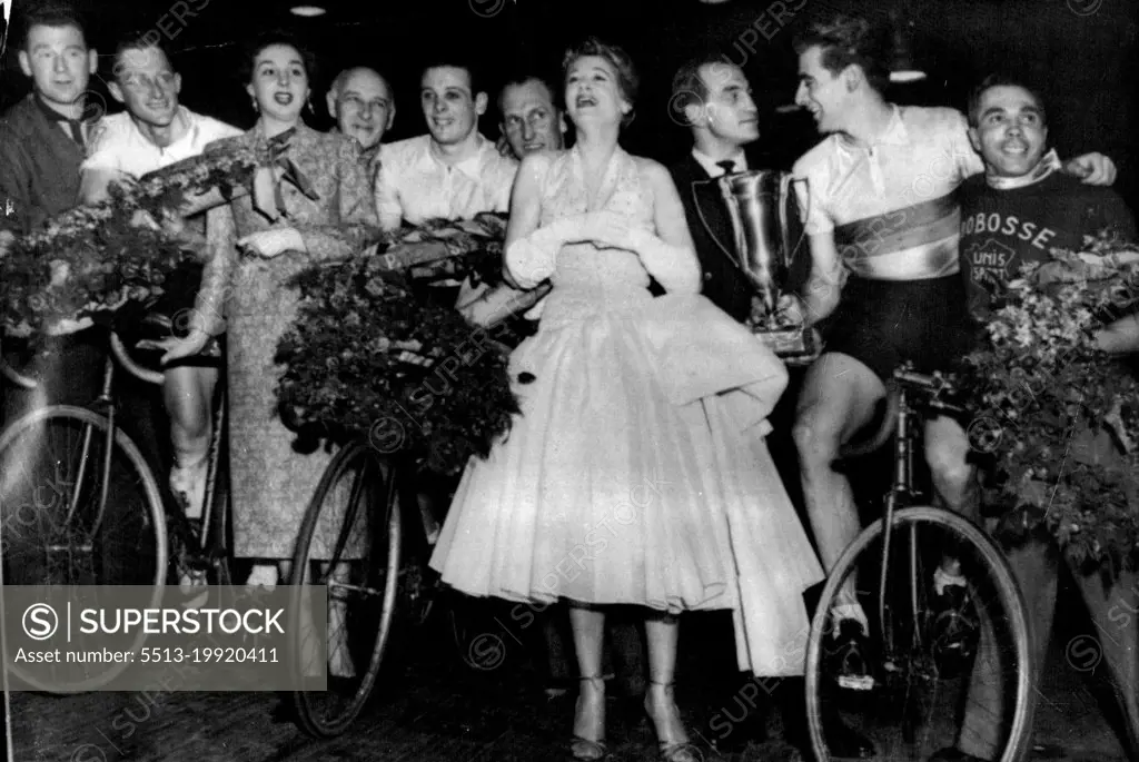Australians win Six-Day Cycle Race:Unidentified; Russell Mockridge (on cycle); Marie Berlioz, Vice Queen of the Race; Unidentified; Reginald Arnold (on cycle); Unidentified; Jacqueline Joubert, Queen of the race; French boxing champion Charles Humez; Sydney Patterson (holding Winners' cup, on Bike); Unidentified.The Australian team after winning the six-day cycle race in Paris last night, March 9. They covered 4,132.5 kilometers at an average speed of 32.34 kilometers an hour (about 2,567.841 miles at an average speed of 20.085 miles an hour). They pulled up from 11th place in the last 24 hours, and took the lead only three hours from the finish. March 18, 1955. (Photo by Associated Press Photo).