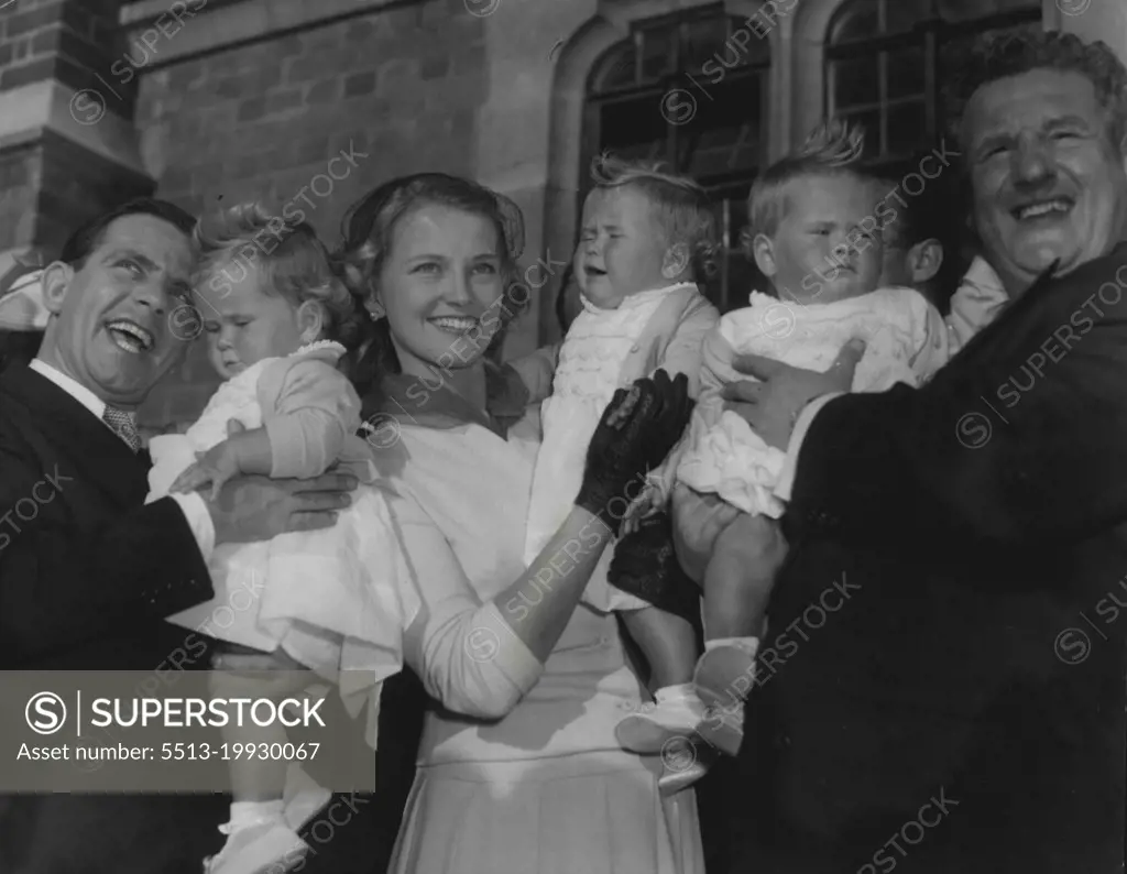 Comedians Triplets Christened. Many famous show people attended the christening at St Phillips Church, Norbury, of the triplet daughters of Tony Fayne and his 30 year oldwife Norma. L to R Comedian Norman Wisdom holding Melinda Jane, singer Joan Regan holding Teresa Anne and Comedian with Hazel Elizabeth. September 26, 1955. (Photo by Daily Herald).