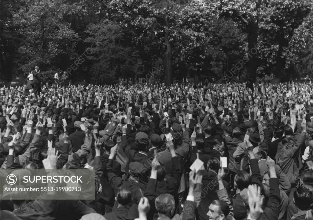 Back To Work On Monday -- The show of hands for "back to work" at the meeting today.By an overwhelming majority on a show of hands, London dockworkers, meeting this morning in Victoria Park, Bethnal Green, decided to return to work on Monday. July 22, 1949. (Photo by Fox Photos).