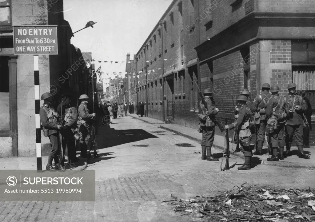 The Belfast Riots -- Troops on guard with fixed bayonets in York Street - the seat of the trouble - in Belfast today, July 14.Troops were called out in Belfast last night, July 13, when rioting between unionists and Nationalists, high began on Friday, flared up again. July 14, 1935. (Photo by Associated Press Photo).