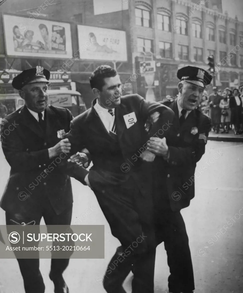 Phone Picket Seized -- Russell Bridge, President of Local 65, Association of Communications and equipment worker is seized by police after a picket line argument as installers and maintenance men renewed picketing of some New Jersey phone exchange because of a still unsettled dispute. June 04, 1947. (Photo by AP Wirephoto).