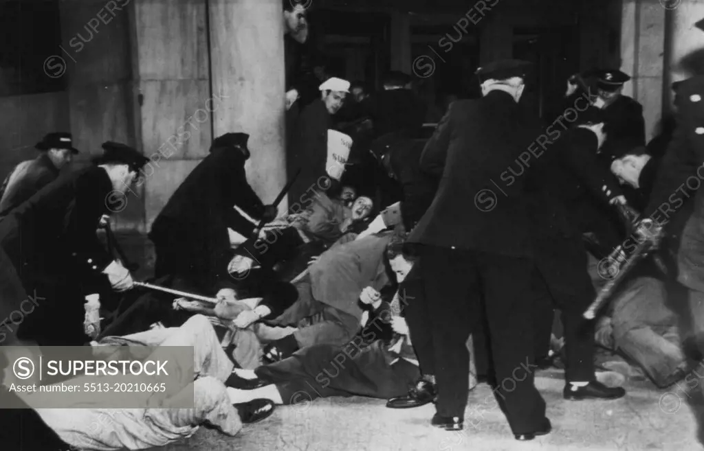 Police Try To Remove Prone Pickets -- Police try to remove pickets at the New York Stock Exchange here today after the pickets stretched flat on the sidewalk before the 11 Wall street entrance to the Exchange in an outbreak of violence in the financial employees strike against the stock exchange and New York Curb exchange. March 30, 1948. (Photo by AP Wirephoto).