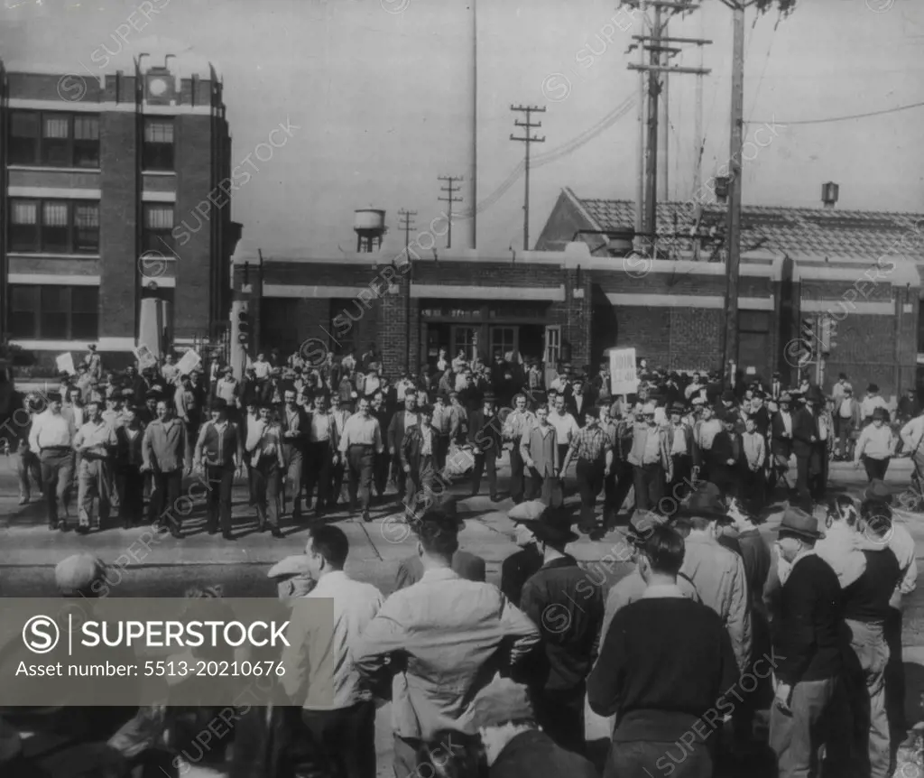 Refinery Employees Walk Out -- Worker walk out of the Sinclair Refining Co., yesterday, joining other plant workers (foreground) in a walkout to enforce demands for a 30% wage increase. September 20, 1945. (Photo by AP Wirephoto).