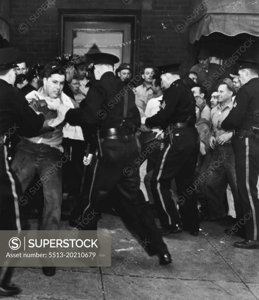 Scuffle: Police scuffle with pickets before offices of the American Marsh Pump Co., here yesterday. Pickets had set up a blockade to prevent office workers form entering the strikebound plant. July 23, 1946. (Photo by AP Wirephoto).