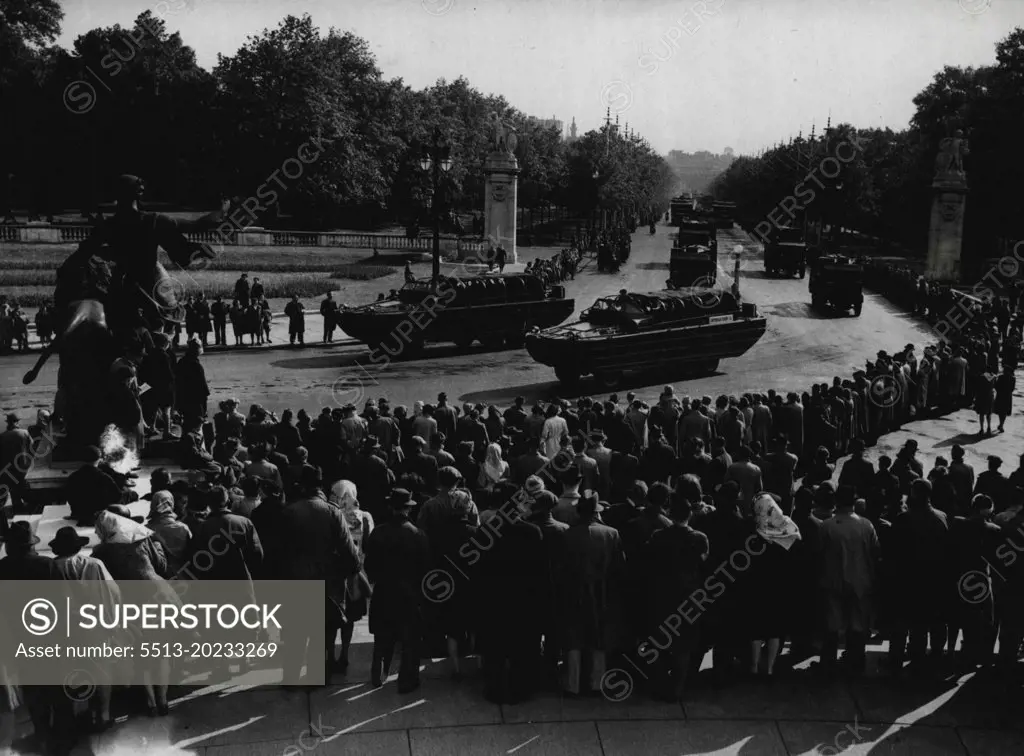 London See Victory Day Rehearsal -- The mechanised procession coming along the Mall towards Buckingham Palace during the rehearsal, watched by the early morning crowd, some of whom waited all night in the rain.Londoners turned out early on the Sunday proceeding Victory Day to watch the full sale rehearsal of the mechanised procession for the Victory Day parade. June 02, 1946.
