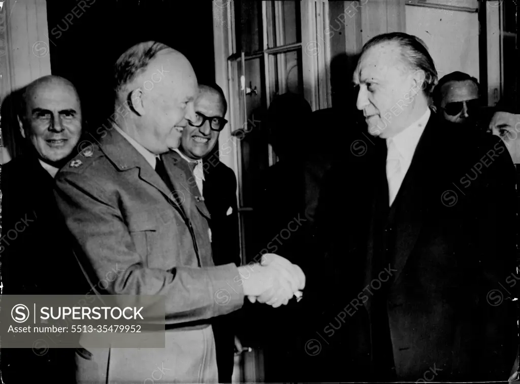 Ike Discusses West Germany's Role - West German Chancellor Dr. Konrad Adenauer (right) shakes hands with supreme allied commander General Dwight D. Eisenhower on the rear porch of Palais Schaumberg, the Chancellor's office in Bonn, May 2. Behind the two are (left to right) U.S. high commissioner John J. McCloy, West German under Secretary of State, Dr. Walter Hallstein, and (in shadows) General Alfred M. Gruenther, Eisenhower's Chief of staff. The supreme commander, who retires at the end of this month, was in Bonn to discuss West Germany's role in Western Defence. May 3, 1952. (Photo by Associated Press Photo)