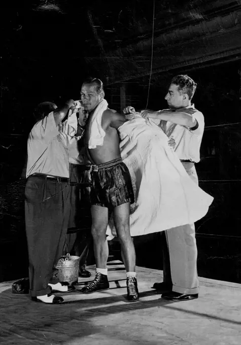 Zale's robe is removed so that he can wrap it loosely over his shoulders while waiting for the fight to begin. November 01, 1948. (Photo by Sporting Life).