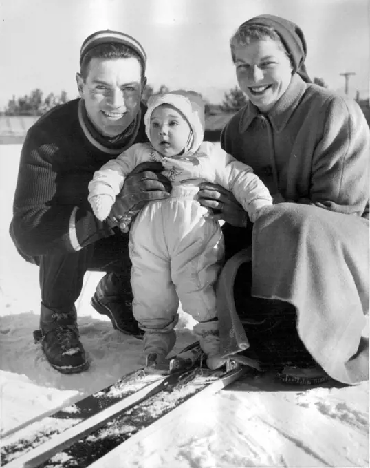 While Daddy's Away -- Art Devlin of the United States Olympic ski jumping team is headed for the Winter Olympics at Cortina, Italy, and while he's away, wife Helen will be taking care of their daughter Jackie, who looks as if she's ready for the snow sport. The members of the team were practicing at Lake Placid. December 31, 1955. (Photo by United Press Photo).