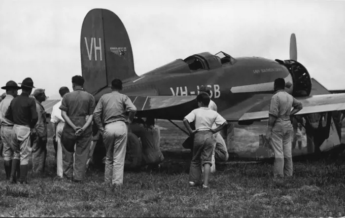 Skilled mechanics at Wheeler Field, U.S. Army airport, working on the "Lady Southern Cross" just as enthusiastically and willingly as they would have if she had been flown by American fliers. December 24, 1934.