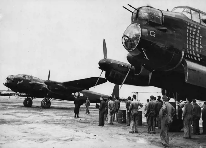 The Lancaster bomber "Aries" on a world navigational flight, drawn up beside another Lancaster "G for George," at Laverton aerodrome, Victoria. "G. for George" is to be exhibited in the National War Museum, Canberra. November 17, 1944.