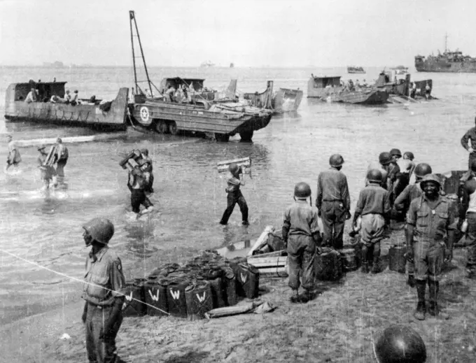 Unloading the Weapons of War: Ducks and amphibious trucks as well as men wading in the water work together to unload supplies for the U.S. fifth army's drive inland from the Salerno beachhead in Italy. September 18, 1943. (Photo by Associated Press Photo).