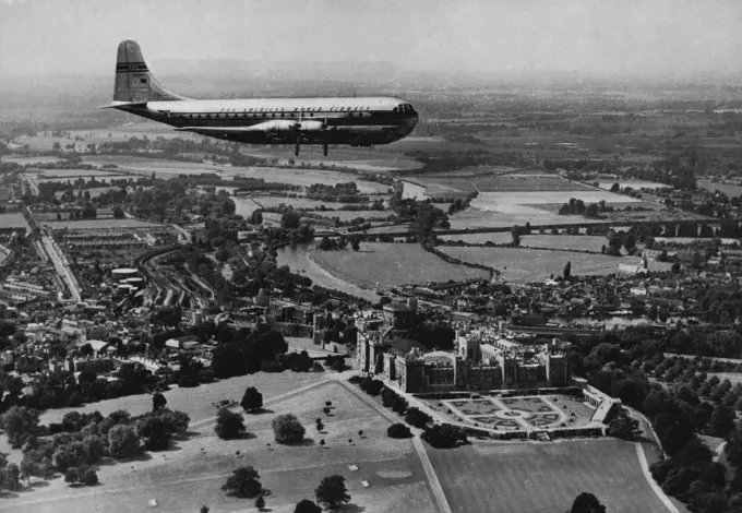 The Span of A Thousand Years Nearly a thousand years of history glides under the majestic wings of this Pan American 'Stratocruiser', world's largest aeroplane in commercial service, as she passes over Windsor Castle en route to London Airport from New York. Beneath the 'Stratocruiser' the Castle - a Royal residence since the days of William the Conqueror (although it was built mainly by Henry III) - spreads its gracious grey bulk on the banks of the River Thames, winding through the chequered B