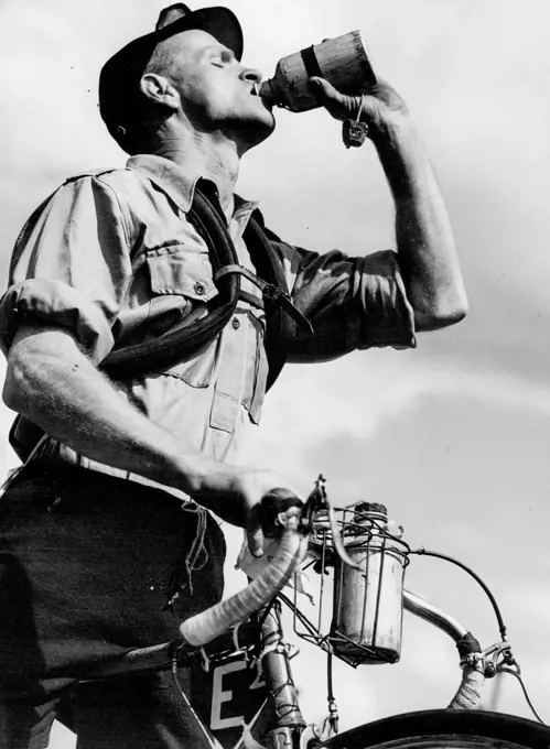 Laurie Sullwan takes a drink from Bidon at Gosford. December 15, 1949.;Laurie Sullwan takes a drink from Bidon at Gosford.