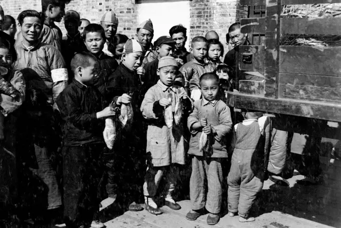 Free Fish -- Children at the CNRRA Refugee Reception Center No.1 receive their share of the 7000 pounds of freshly caught deep sea fish distributed free by CNRRA today to 9 Shanghai charitable institutions. The fish was caught by UNRRA deep sea fishing boats of the Fishery Rehabilitation Administration at point Island. April 24, 1947. (Photo by Ping, UNRRA).;Free Fish -- Children at the CNRRA Refugee Reception Center No.1 receive their share of the 7000 pounds of freshly caught deep sea fish d