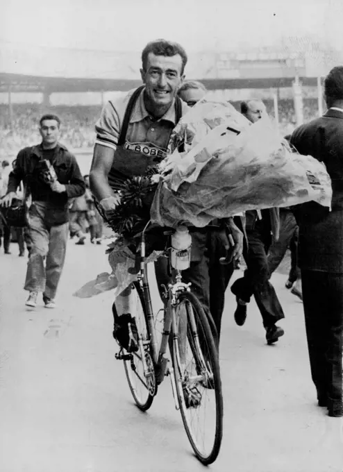 Bobet Scores Tour de France Hat-Trior - Louison Bobet of France won his third straight Tour de France on, Saturday. He is shown here with the winner's wreath, while making the traditional winner's tour of the arena, in this case the Parc des prices in Paris. August 01, 1955. (Photo by Paul Popper Ltd.). sports, sport, athlete, athletic, 