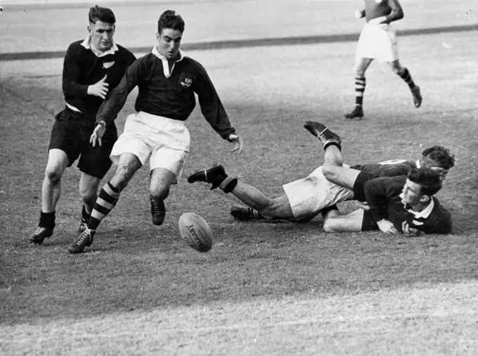 Lines for Rugby Union test pictures: No. 1 Rival centres Alan Walker (Aust White Shorts) (NZ) at left scrimmage for the ball. At inside centre, one favored position, Alan Walker races M. Goddard (NZ). July 01, 1947.