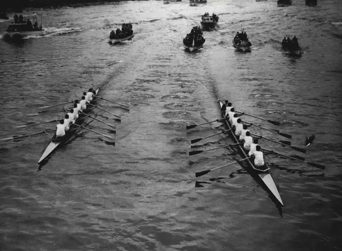 The race approaches Hammersmith Bridge. Oxford are on the right. Oxford supporters are chuckling over a victory for "psychological" warfare." They reckoned that their rumoured secret weapon for nerves had Cambridge worried from the start of this hundredth race, which Oxford won by for and a half lengths. For the Dark Blues, with four Australians in their crew, held the lead from the first stroke against the heavier Cambridge crew, who had been dosed with vitamin capsules. On the eve of the race there had been rumors that Oxford were taking phenobarbitone pills to steady their nerves. April 5, 1954. (Photo by Daily Mirror). 