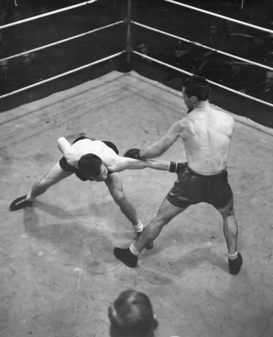 Les Sloane knocks down a long left by Sel Hamilton during their fight at the Stadium last night. July 28, 1946. 