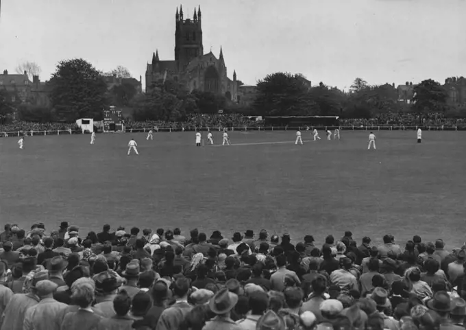 Australian Test Tour Opens. Packed to capacity. A general view of the picturesque county ground at Worcester during the morning's play. Worcester Cathedral is shown in background. The Australian Cricket Team opened their English tour today with a 3~day match against Worcester. April 28, 1948. (Photo by Fox). 
