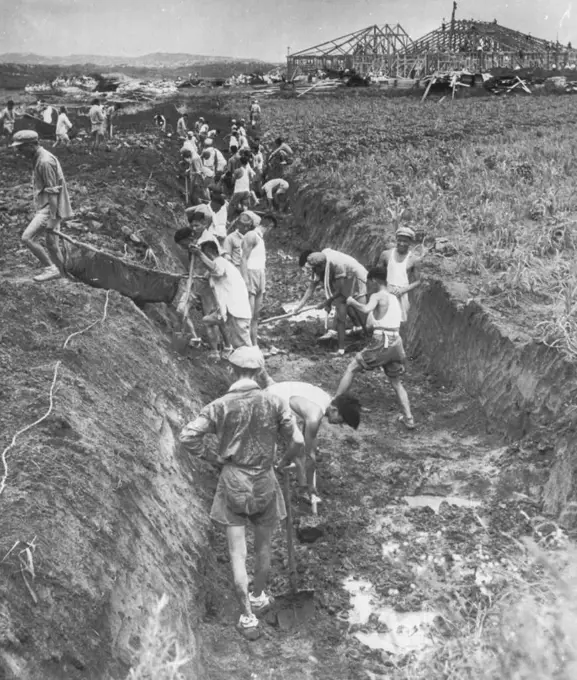 Road to Peace -- North Korean laborers use stretcher-like slings to carry dirt from a ditch to a road under construction (left) at Panmunjom. The road leads to Armistice hall under construction in the background and which is scheduled to be the scene when an armistice is signed to end the fighting in Korea. July 24, 1953. (Photo by AP Wirephoto).