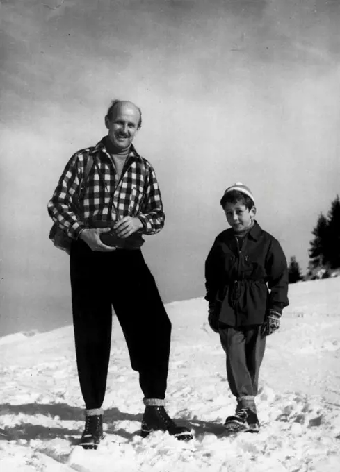 On Winter Sports In Switzerland: Michael Powell, British Film Producer. Photographed on the Wasserngrat heights above Gstaad, with his eight year old son Kevin. March 9, 1954. (Photo by Brodrick Haldane, Camera Press). 