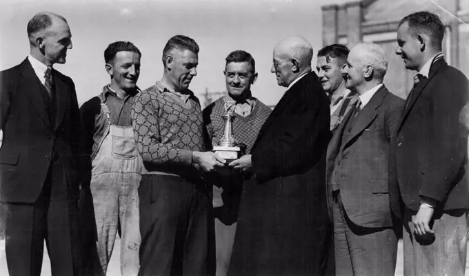 Presentation of "Sun" Challenge Cricket trophy to the Railways Institute Electric car *****, Chullora team, the team has won the trophy for the last 3 seasons, At this season were undefeated. Trophy is presented to premier team in Railway Institute competition. L to R. - W. White, works manager of Patron, ***** (player), W. Williams, (V. Capt) L. Mills, President, Geo Nicholas Director of Institute making presentation, H. Ryon, Sec. J. Russell, Sec of Institute & W. Wand, player. May 29, 1939.