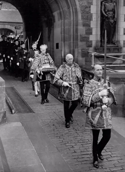 The Queen in The Northern Kingdom. The honours of Scotland leaving Edinburgh Castle for the palace of Holyrood House, prior to being taking in procession to St. Giles Cathedral. Leading is Colonel H.A.B. Lawson (Rothesay Herald) carrying the sword. Behind him is Colonel J.W. Balfour Paul, Marchmont Herald, carrying the scepter. In rear is is the senior Scots herald, Lord Lyon Sir Thomas Innes of Learney; he carries the crown. June 25, 1953. (Photo by Paul Popper).