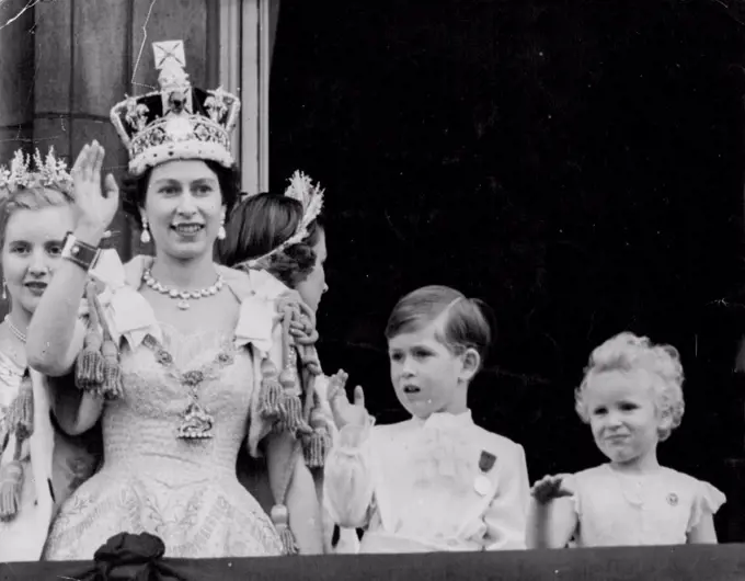 Crowned Queen And Her Children Wave From Palace Balcony -- Smiling and wearing the Imperial State Crown, the Queen is joined by her children, Prince Charles and Princess Anne, in waving from Buckingham Palace balcony to the cheering crowds in front of the Palace after the Coronation to-day (Tuesday). On left, behind the Queen, is Lady Anne Coke, one of the Queen's six maids of Honour at the Coronation. As the Queen, the Duke of Edinburgh and other members of the Royal Family appeared on the balcony, 168 jet fighters flew over in the Royal Air Force salute to the newly-crowned Sovereign. June 02, 1953.