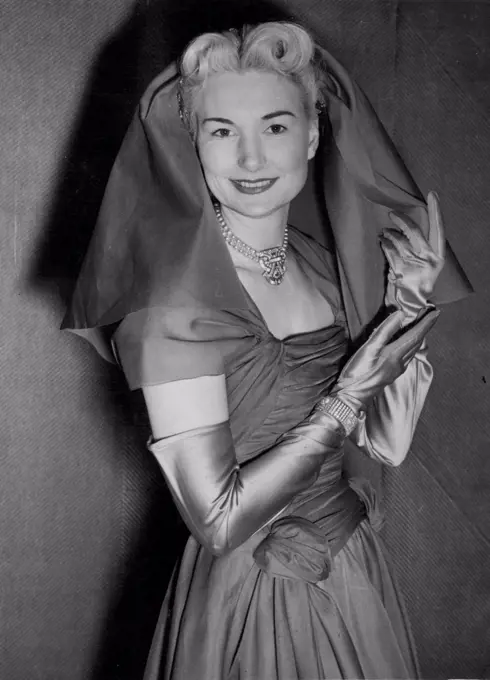This Organza coif, for wear with an afternoon or evening dress, falls from the crown of the head to the shoulders and does not cover the face. January 11, 1953. (Photo by Planet News Ltd.).