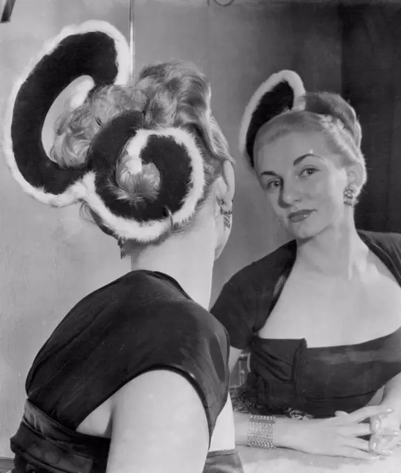 Coronation Goes To Her Head -- Paula Marko this "Royal E" hairstyle with the Queen's cypher carries out in scarlet and ermine. It was one of the variations of his New Elizabethan hairstyle presented by Riche of London of Coronation year. October 29, 1952.