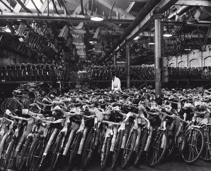 British Bicycles For The World -- Cycles for Wholesale and retail traders are despatched fully assembled. The foreman is seen here checking the guarantee and despatch notes before the cycles are loaded for despatch. July 09, 1951. (Photo by Central Office Of Information photograph).