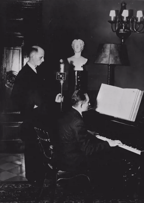 Wanger's Piano On The Radio -- The NBC network recently broadcast a commentary from Bayreuth, during which M. Conrad Hasen played on the original piano of Richard Wagner. Standing up we see Dr. Max Jordan, European NBC representative. August 20, 1942. (Photo by Radio-Press- Service).