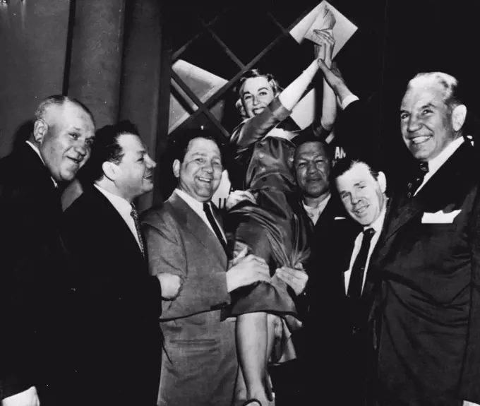 Doctor Winner of 'Operation $64,000' - Dr. Joyce Brothers, 28-year-old psychologist, is hoisted to the shoulders of some of her "staff" of boxers after winning the final and $64,000 question on the the television program of that name here tonight with her knowledge of boxing. Left to right are: Marty Sommers, A.E.F. fighter in World War I; Tony Canzeneri, Gus Lesnevich, Dr. Brothers, Bob Olin, Mickey Walker and Eddie Eagan, former Olympic boxing champion and former New York State Athletic commissioner who ***** Dr. Brothers. December 06, 1955. (Photo by AP Wirephoto).