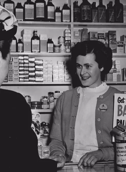 Easy Medicine To Take: Pretty twenty three years old Val. Markham who works in a Chemist shop at Kograh (NSW) dispensed herself a pleasant dose when she won all the Cop The Lot! prizes on Bob Dyer's quiz session last night over 2ve (Tuesday 29th July). Knowing Bernard and Erwin, respectively, as the Christian names of famous Generals Montgomery and Rommel copped her the lot! July 30, 1952. (Photo by Scott Polkinghorne).
