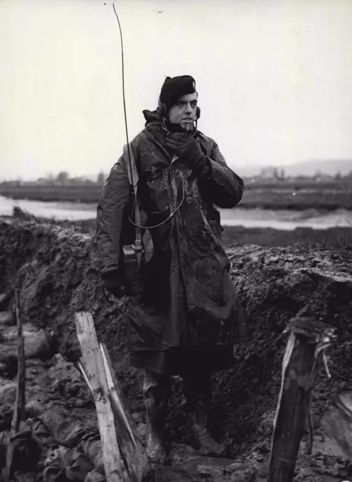 Canvey Waits For The Test - Canvey was today making hurried preparations resist the highest tide which is expected to be on Sunday, and this picture shows "walkie-talkie" control with ops room from the seriously boeached east wall of the Island. February 12, 1953.