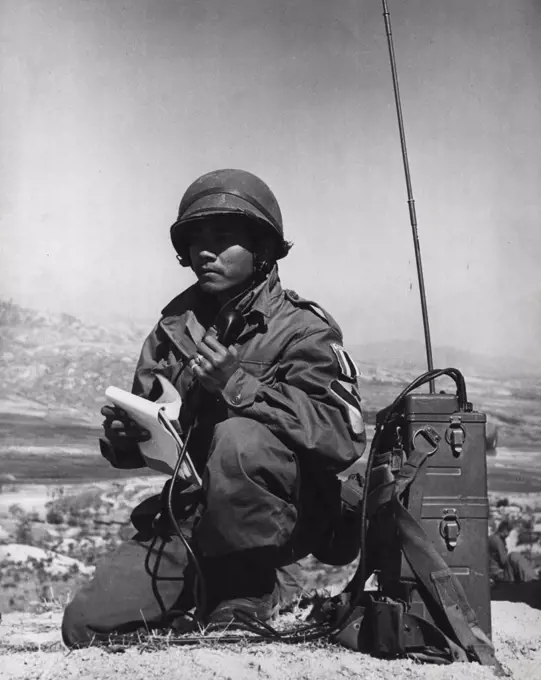 A soldier from Thailand, at a forward observation post in Korea, reports to his unit by radio. July 06, 1951. (Photo by United States Information Service).
