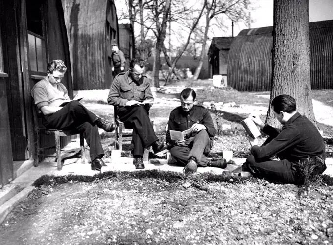 Re-Educating German P.O.W.'s Reaeducating themselves - a leisure moment in the sun outside one of the Nissen huts in Wilton Park. The political Intelligence Department of the Foreign office is working hard re-educating German prisoners of war at the "Pow University" established in Wilton Park, Beaconsfied. German captives, carefully graded after an intensive survey, have become students in an experiment which it is hoped will prove successful and useful to the future of the world. The idea of the Training Centre is to remove the prisoners' faith in the Nazi idea, to prove to them that might is not always right, to show them that the Nazi version of history for the past 50 years was false, and to explain the British way of life and institutions, not as an example to be slavishly copied, butin order that they may see how the democratic theories work. May 15, 1946. 