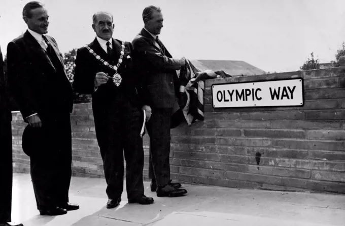 "Olympic Way" Opened In Readiness For The Games -- Lord Burghley (left) with Councillor H. Sirkett, Mayor of Wembley, look on as Mr. Alfred Barnes unveils the name-plate of the new "Olympic Way'. The official opening of the new road which has been constructed form Wembley Park Station to the Empire Stadium, was performed by Mr. Alfred Barnes, Minister of Transport. The road - named "Olympic Way" will greatly facilitate the movement of traffic and visitors to the Olympic Games. July 7, 1948. (Photo by Sport & General Press Agency Limited).
