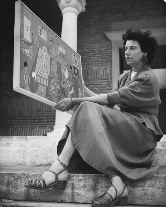 Peggy Guggenheim in Venice Mrs. Guggenheim shows also this painting of a really new conception. "Interior" is its title and the artist's name is Pageen ***** Peggy's daughter of the first marriage. January 11, 1949. (Photo by Interfoto).