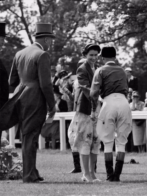 Queen's Handshake For Royal Jockey -- The Queen smilingly shakes hands with her jockey, W.H. Carr, in the paddock at Epsom, Surrey, to-day (Friday). Carr was about to ride the Queen's filly Angel Bright in the Oaks Stakes, the fillies' classic. She was unplaced in the race, which was won by the French entry Sun Cap. June 4, 1954. (Photo by Reuterphoto).