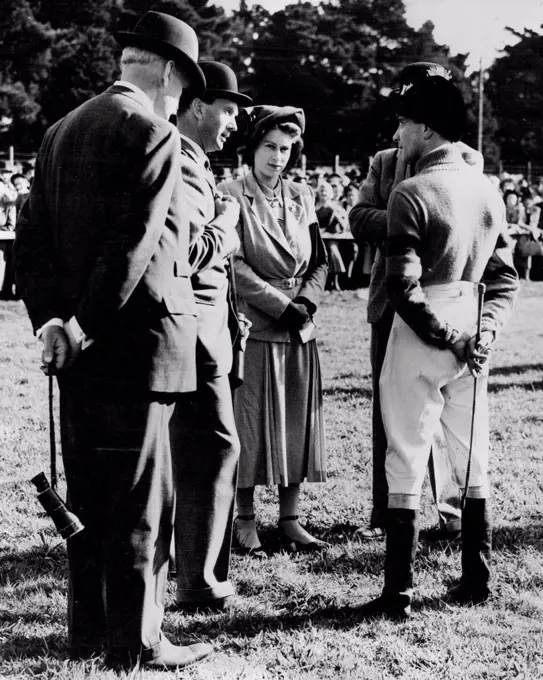 Princess Has A word With Her Jockey - Princess Elizabeth talking with her jockey A. Grantham, at Fontwell-Park today. Standing next to the Princess on left is Monaveen's trainer, Peter Cazalet. Princess Elizabeth was at Fontwell Park to-day (Monday) to watch Monaveen, the Grand National candidate which she owns in partnership with the Queen, win the Chichester Handicap Chase - his first outing in his new colours. Monaveen, ridden by A. Grantham, defeated Random Knight (second) and Mart in M (third ). The Princess had returned earlier in the day from Balmoral after the Royal Family's holiday. October 10, 1949. (Photo by Reuterphoto).