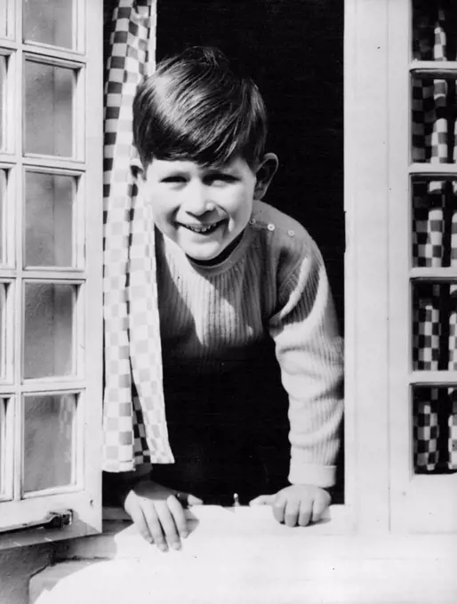 Happy Prince -- This happy picture of Prince Charles was taken by Royal photographer Lisa, as the young Prince looked out from the kitchen window of the Welsh House at Royal Lodge Windsor. April 22, 1954. (Photo by Paul Popper Ltd.).