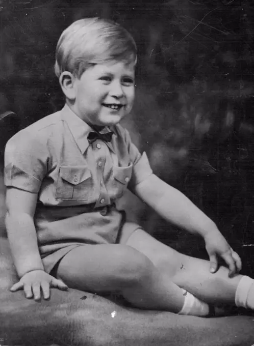 Prince Charles, dressed for a State occasion, wears a romper suit and an American-style bowtie. He is fair-haired, blue-eyed. Prince Charles... in baby bow tie, double breaster. Bow ties are smart for boys, as Prince Charles shows here. He wears this one with check romper suit. March 24, 1952. (Photo by The Associated Press Ltd.).