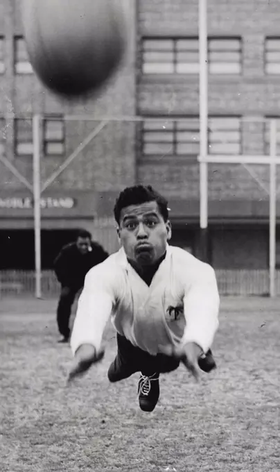 Fijian RU - Away it goes. Vatubua grimaces as he throws himself and ball into the air. July 26, 1952.