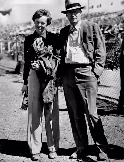 Amelia Earhart and her husband George Palmer Putnam  posing together at an outdoor event.Putnam-No.8. March 04, 1938. 