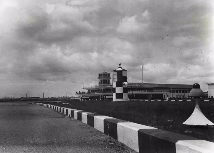 Another scene showing the red and white brick-edged runways the light tower, Airport building and l extreme right i red indicator lights, set on a white base, which are placed at short intervals along each runway. March 03, 1938.