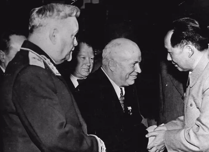 Rulers Of Soviet Russia And Communist China -- Photographed at Peking in October, 1954, on the occasion of the opening of special Soviet Exhibition. Nikita Khrushchev, Secretary-General of the Soviet Communist Party, is seen shaking hands with Mao Tse Tung. Chairman of the Chinese people's republic. On the left is Marshal Bulganin, the new Soviet Prime Minister. February 15, 1955. (Photo by Camera Press). 